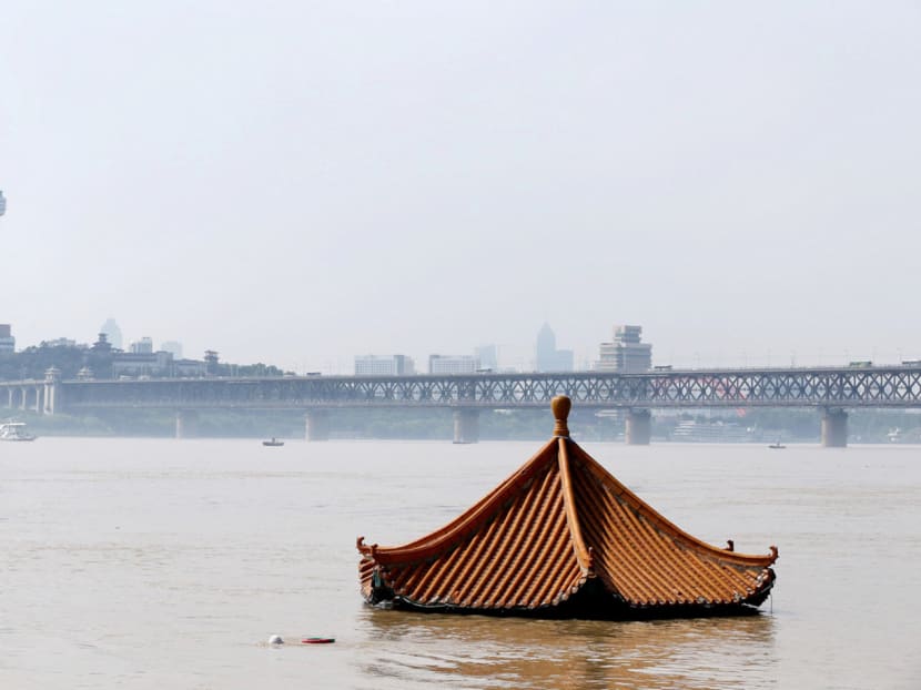A pavilion lies submerged in the flooded Yangtze River in Wuhan, Hubei province. Weeks of torrential rain triggered flooding along lakes and rivers in six provinces that has killed more than 160 people, damaged over 4.1 million hectares of crops and led to economic losses of more than S$21 billion. Photo: Reuters