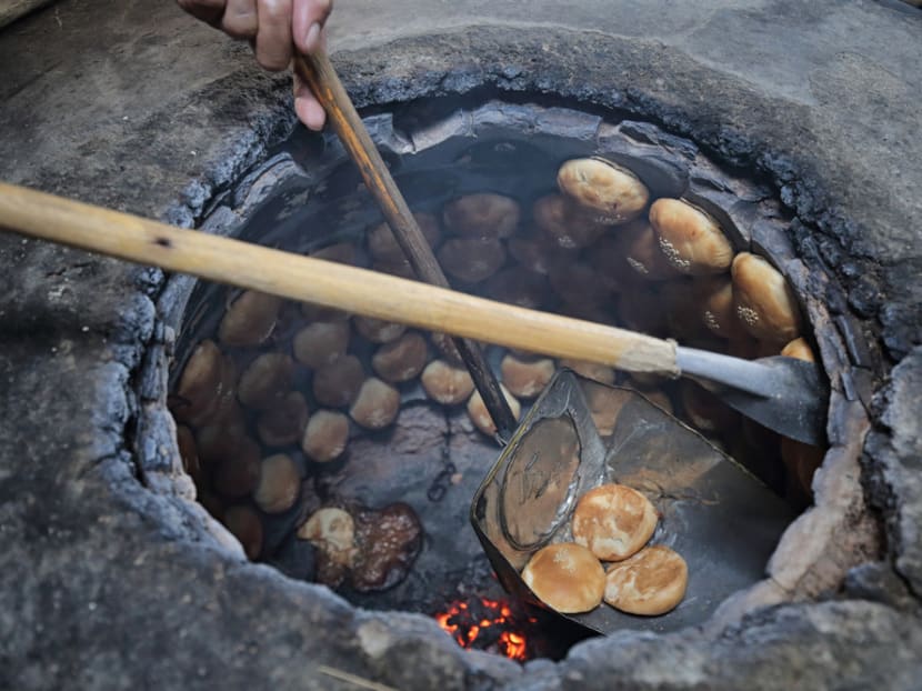 The 'heong peah' are baked to golden brown inside the kiln.