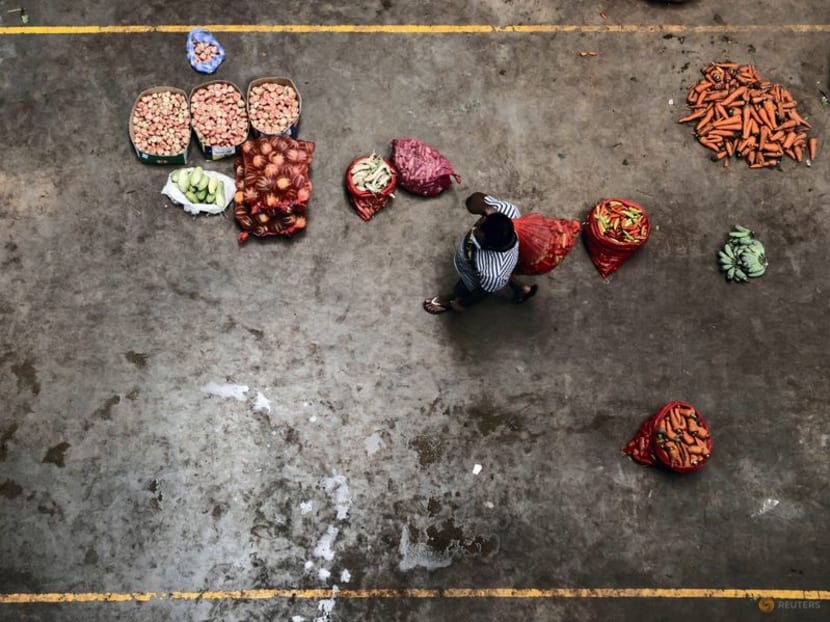 FILE PHOTO: A man walks past a vegetables stall at a wholesale market, amid the country's economic crisis in Colombo, Sri Lanka, April 13, 2022. REUTERS/Dinuka Liyanawatte