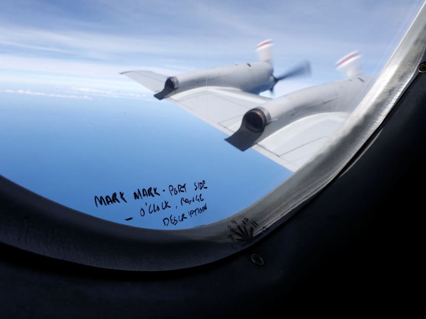 Handwritten notes on how a crew member should report the sighting of debris in the southern Indian Ocean is pictured on a window aboard a Royal New Zealand Air Force P-3K2 Orion aircraft searching for missing Malaysian Airlines flight MH370, on March 22, 2014. Photo: Reuters