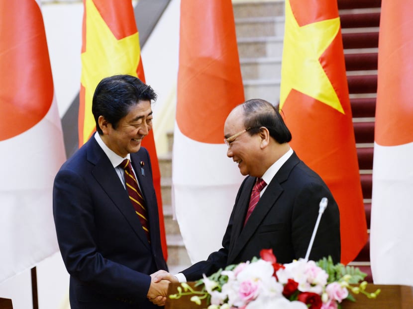 Japanese Prime Minister Shinzo Abe (left) meeting Vietnamese Prime Minister Nguyen Xuan Phuc 

after a joint press briefing in Hanoi yesterday. Vietnam was Mr Abe’s last stop on a four-nation tour. Photo: AP