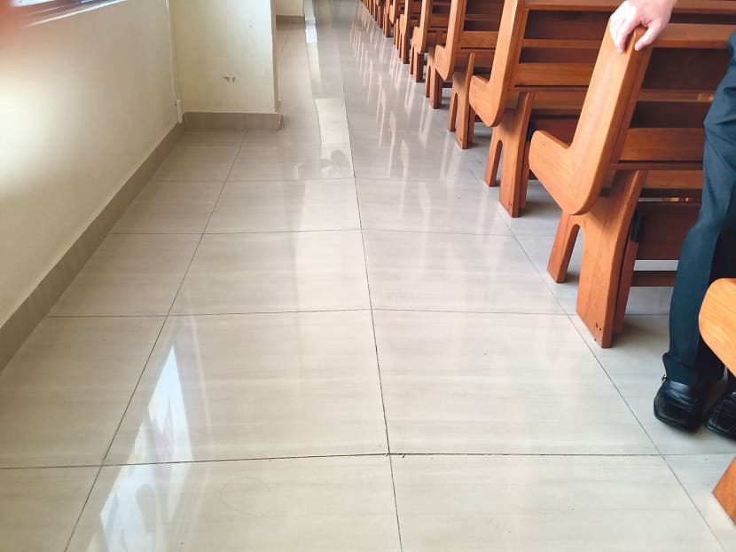 Besides the buckled tiles on the left side of the chapel of the Church of the Holy Spirit, there were also chipped tiles between the pews and loose tiles along the main aisle of the chapel. Photo: Joy Fang
