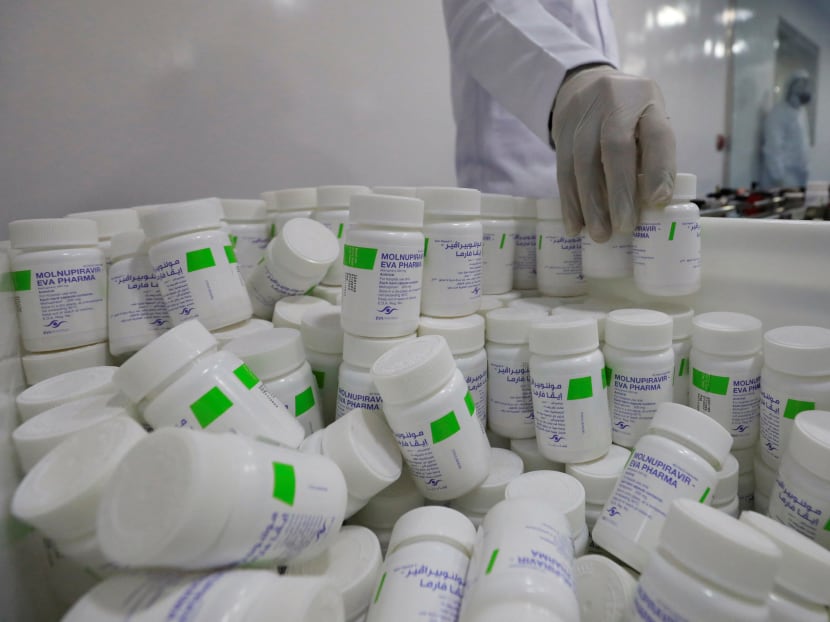 A lab technician holding packaged products of molnupiravir, a drug used in the treatment of Covid-19, in a packing unit at Eva Pharma in Cairo, Egypt.