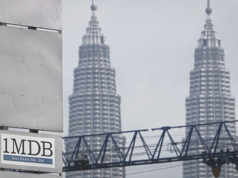 A 1MDB logo is set against the Petronas Twin Towers in Kuala Lumpur, Malaysia. AP file photo