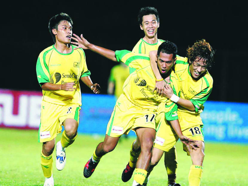 HAPPIER TIMES: Woodlands Wellington striker Masrezwan Masturi celebrating a goal with his teammates in an S.League match in 2005. TODAY FILE PHOTO