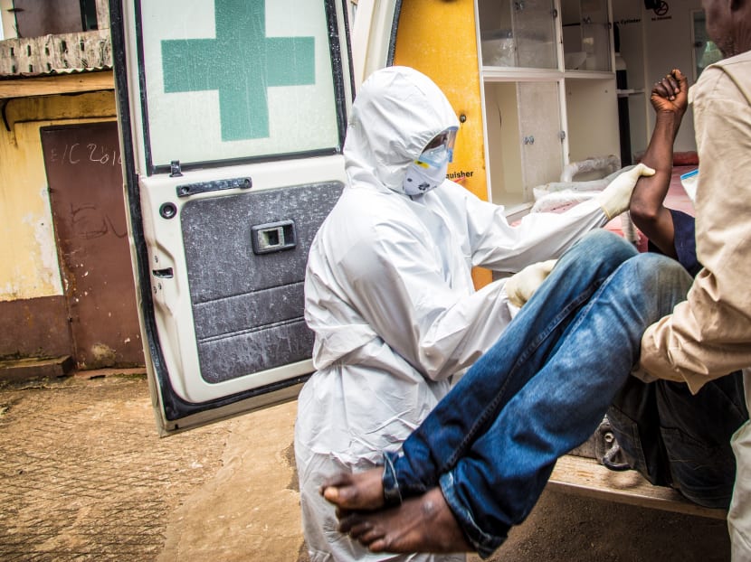 In this Sept 24, 2014 file photo, health workers load a suspected Ebola patient into the back of an ambulance in Freetown, Sierra Leone. Photo: AP