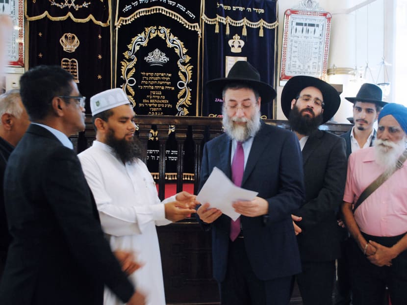 Imam Nalla Mohamed Abdul Jameel (second from left) meeting Rabbi Mordechai Abergel at the Maghain Aboth Synagogue yesterday. The visit included religious leaders from Singapore’s Buddhist and Sikh communities. Photo: WISE SG