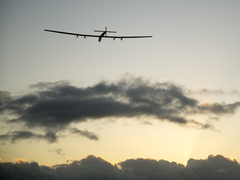 The Solar Impulse 2 solar plane flies into the sunrise out of Kalaeloa Airport on April 21, 2016, in Kapolei, Hawaii.  Photo: AP