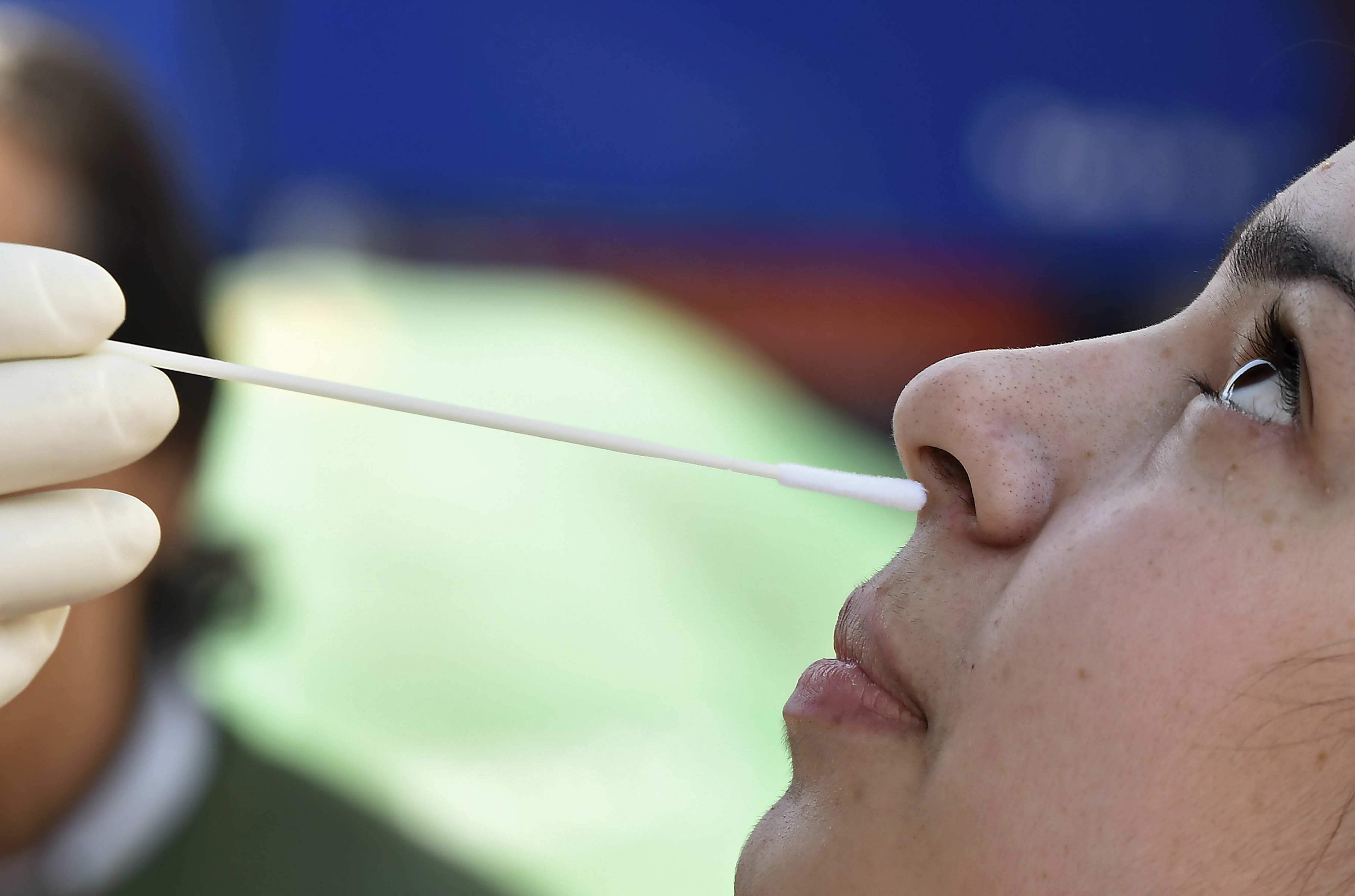 A medical worker collects a swab sample from a woman for a rapid antigen test for Covid-19 in Srinagar, India.