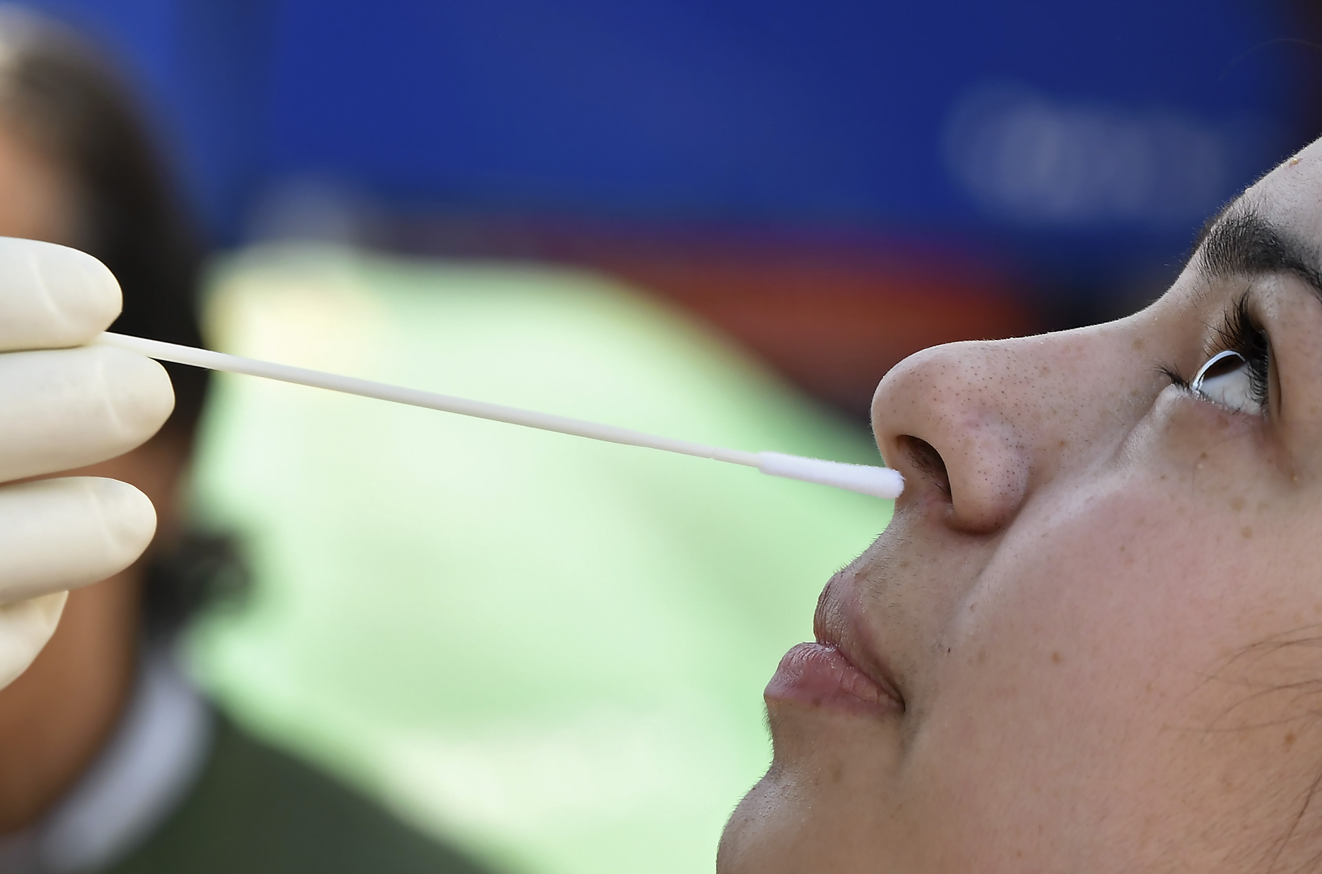A medical worker collects a swab sample from a woman for a rapid antigen test for Covid-19 in Srinagar, India. A medical worker collects a swab sample from a woman for a rapid antigen test for Covid-19 in Srinagar, India.