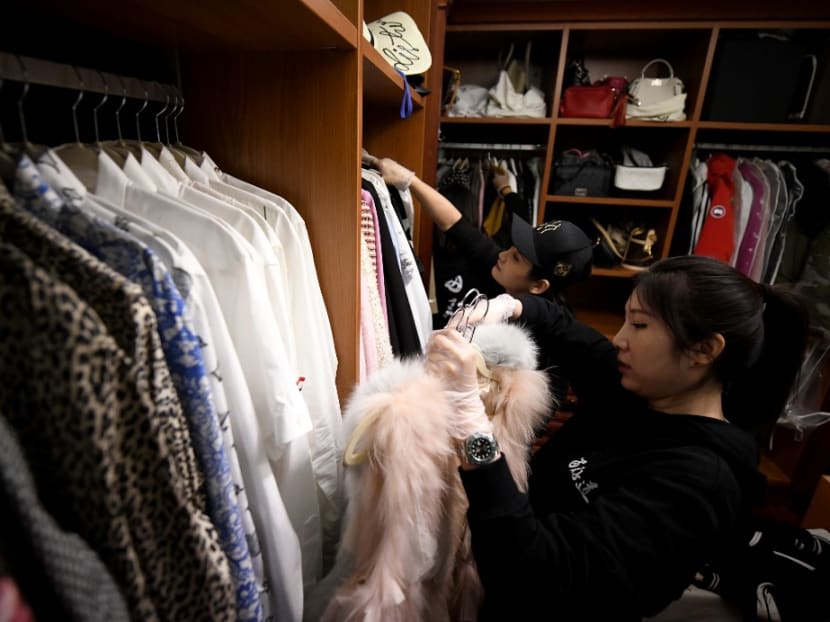 This photo taken on Oct 26, 2020, shows home organisers arranging the luxury wardrobe of client Chen Rui in Beijing.