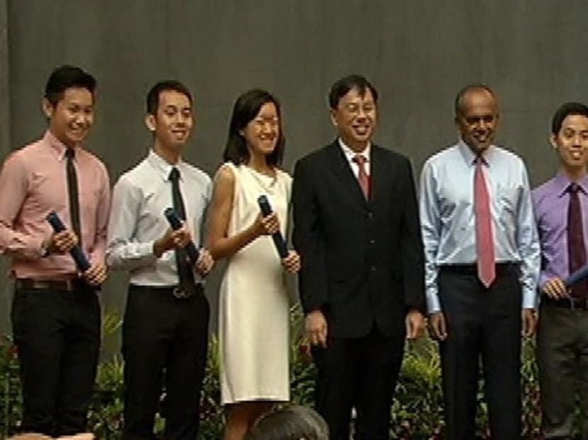 Minister for Foreign Affairs K Shanmugam (centre) with some of this year's Foreign Service Scholarship recipients.  Photo: Channel NewsAsia