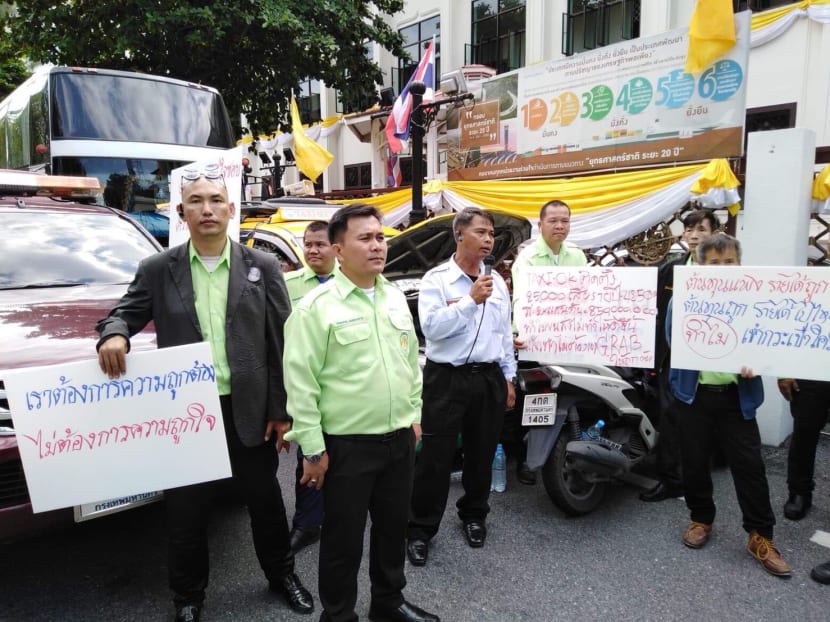 Leading the rally of his Association of Public Taxi Motorists, Mr Worapol Kaemkhunthod (second from left) said taxi drivers opposed all forms of ride hailing services, including GrabTaxi, because they took advantage of conventional taxi drivers.