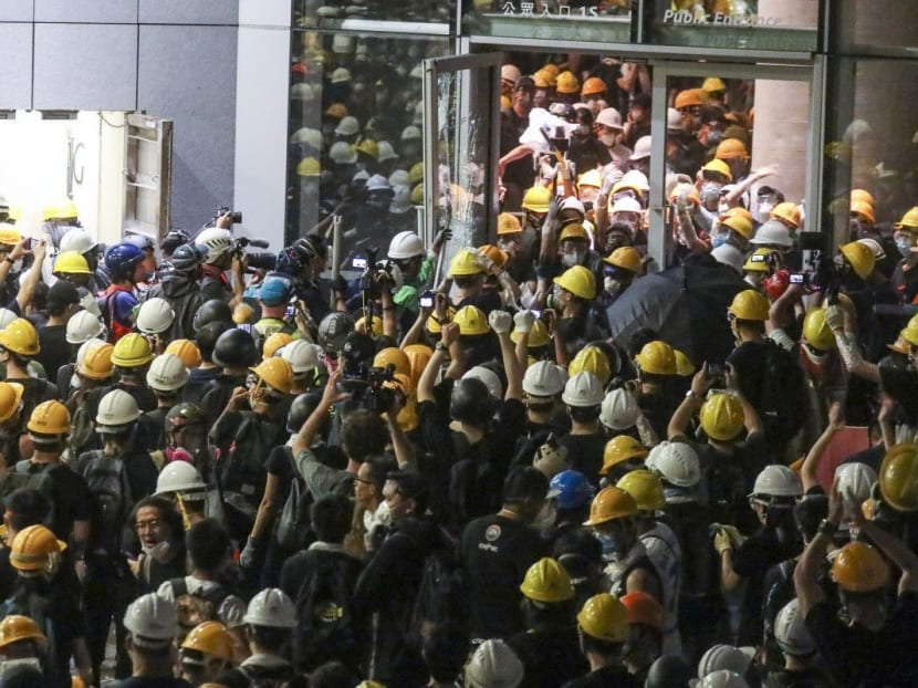 Protesters enter the Legislative Council building during a protest against the extradition bill on Monday.
