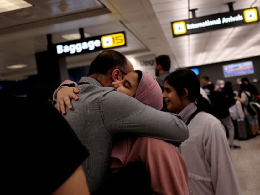 A Saudi family embraces as members arrive at Washington Dulles International Airport after the US Supreme Court granted parts of the Trump administration's emergency request to put its travel ban into effect later in the week pending further judicial review. Photo: Reuters