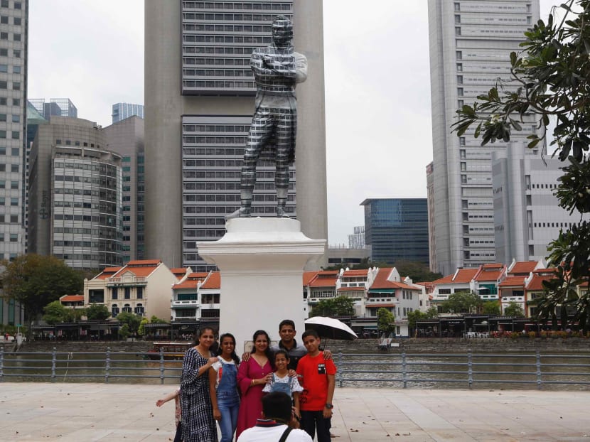 People posing in front of an optical illusion involving the statue of Sir Stamford Raffles. The author notes that there is a wide range of colonial experiences across the world, and in some cases, Western colonisation have left a positive legacy. People posing in front of an optical illusion involving the statue of Sir Stamford Raffles. The author notes that there is a wide range of colonial experiences across the world, and in some cases, Western colonisation have left a positive legacy.