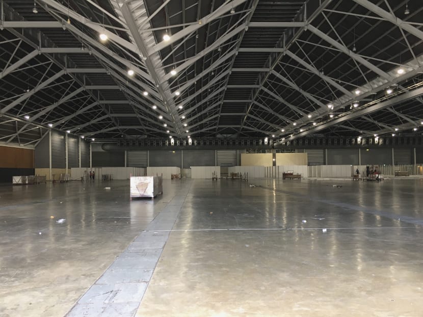 Workers seen on April 5, 2020 preparing a hall at the Singapore Expo to be used as a community care facility for recovering Covid-19 patients.