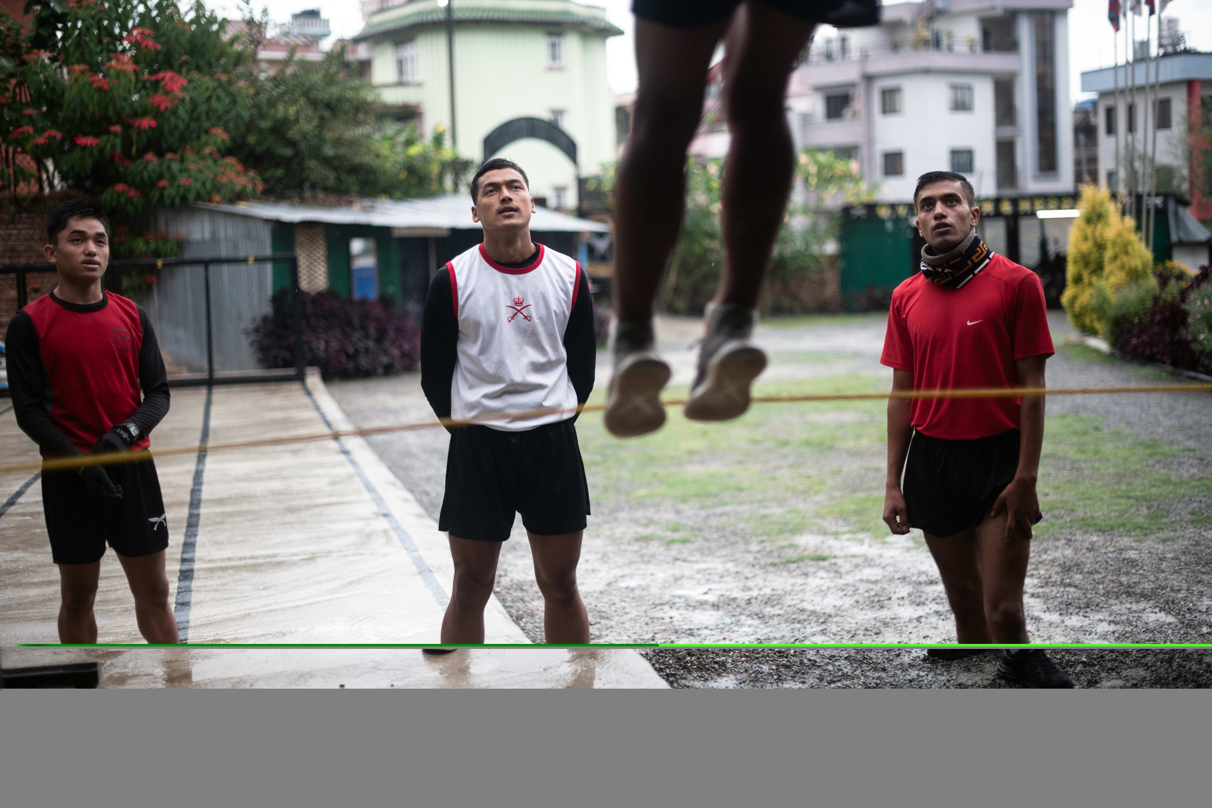 Mr Rabin Mahat, right, watches as fellow applicants train for a place in the British army as a Gurkha soldier, in Kathmandu, Nepal on Oct. 19, 2021. Mr Rabin Mahat, right, watches as fellow applicants train for a place in the British army as a Gurkha soldier, in Kathmandu, Nepal on Oct. 19, 2021.