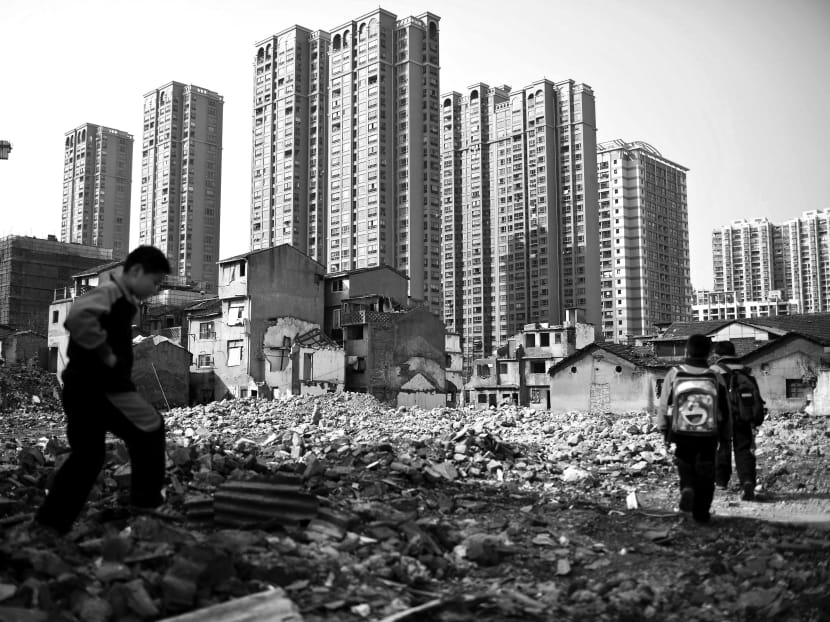 Old residential buildings in central Shanghai are being demolished to make room for skyscrapers. A recent study by the International Monetary Fund argues China may have been over-investing by between 12 and 20 per cent of its gross domestic product, with some of the money spent on real estate likely to have been squandered. Photo: Reuters