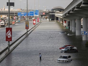 A person stands surrounded by flood water caused by heavy rains, in Dubai, United Arab Emirates on April 17, 2024.