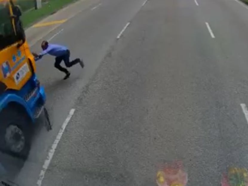 A screengrab from an in-vehicle recording shows a pedestrian being hit by an incoming trailer truck. A screengrab from an in-vehicle recording shows a pedestrian being hit by an incoming trailer truck.