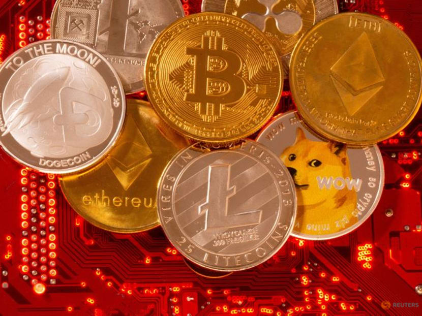 FILE PHOTO: Representations of cryptocurrencies Bitcoin, Ethereum, DogeCoin, Ripple, Litecoin are placed on PC motherboard in this illustration taken, June 29, 2021. REUTERS/Dado Ruvic/Illustration/