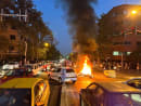 FILE PHOTO: A police motorcycle burns during a protest over the death of Mahsa Amini, a woman who died after being arrested by the Islamic republic's "morality police", in Tehran, Iran September 19, 2022. WANA (West Asia News Agency) via REUTERS 