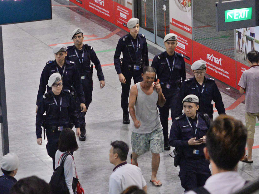 The 39-year-old man (in singlet) who sparked the security scare at Hougang MRT Station was arrested for causing public alarm. He is 
now out on bail. 
TODAY file photo