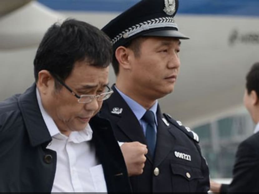 Photo from China's Central Commission for Discipline Inspection shows Li Huabo being led by police out of an aircraft upon arriving in China back in 2015.