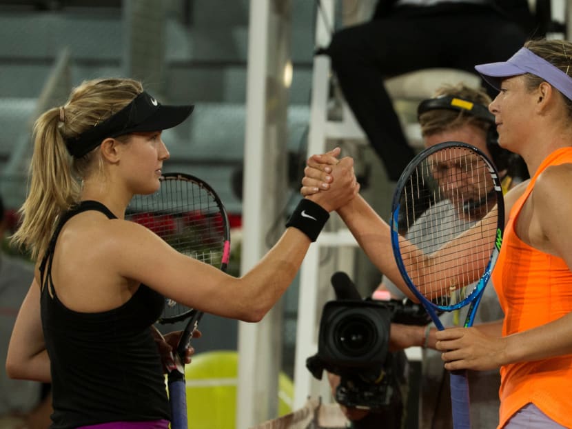 Eugenie Bouchard (left) shakes hands with Maria Sharapova after the match. Photo: Reuters