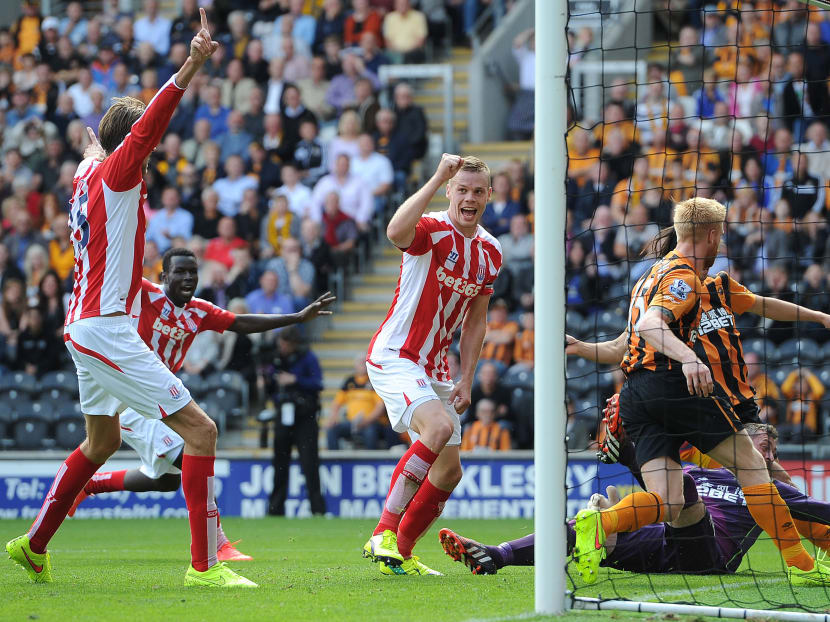 Stoke City's Ryan Shawcross (centre) elated after scoring his team's first goal against Hull City, during their English Premier League match at the KC Stadium, Hull, England, Aug, 24, 2014. Photo: AP