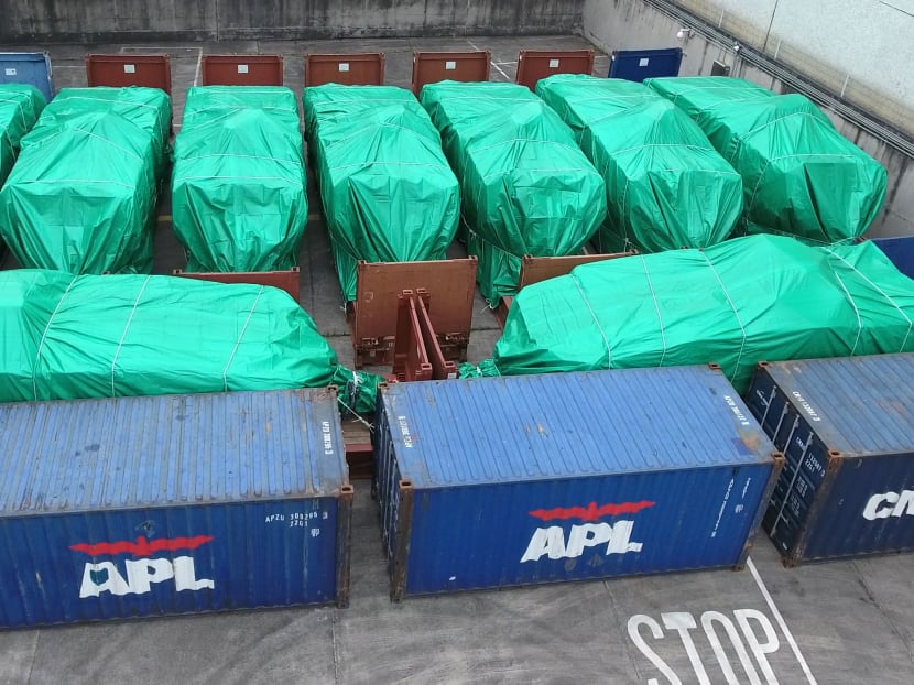 The 9 SAF armoured vehicles seized in Hong Kong, now covered in green sheets, have been moved to the customs cargo examination compound at the River Trade Terminal. Photo: Factwire