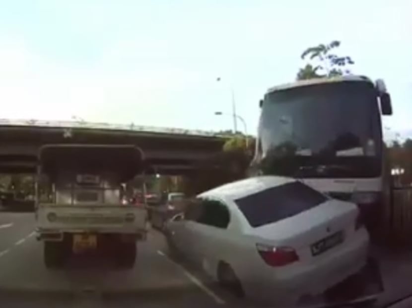 Screenshot taken from a car's dashcam video shows a private bus after it had crashed through a road divider along Pioneer Road North, Jan 12, 2017. Photo: Tony Ng