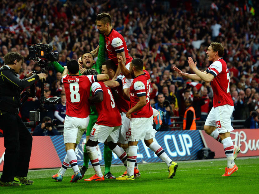 Lukasz Fabianski of Arsenal celebrates winning the penalty shoot out with team mates during the FA Cup Semi-Final match between Wigan Athletic and Arsenal at Wembley Stadium on April 12, 2014 in London, England. Photo: Getty Image