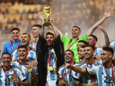 Argentina's Lionel Messi lifts the World Cup trophy alongside teammates as they celebrate winning the World Cup on Dec 18, 2022.