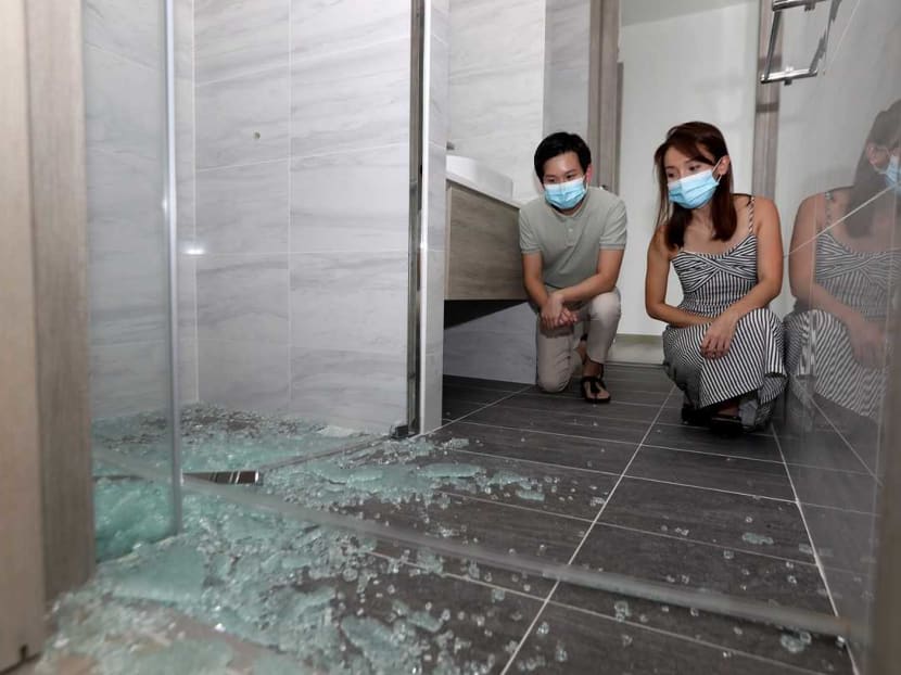Siblings Mr Edward Quek, 31, and Ms Janelle Quek, 35, with a bathroom door which they say shattered and collapsed for no apparent reason. Siblings Mr Edward Quek, 31, and Ms Janelle Quek, 35, with a bathroom door which they say shattered and collapsed for no apparent reason.