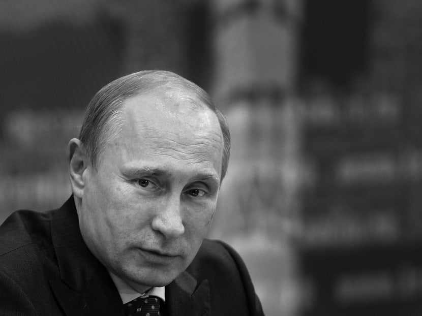 Russian President Vladimir Putin listens during a meeting in Samara, Russia, Monday, July 21, 2014. Putin has lambasted those who use the downing of a passenger jet in eastern Ukraine for “mercenary objectives,” the Kremlin said Monday. In a statement posted on the Kremlin website, Putin again lashed out at Ukraine for ongoing violence with pro-Russian rebels in the eastern part of the country. (AP Photo/RIA-Novosti, Alexei Nikolsky, Presidential Press Service)