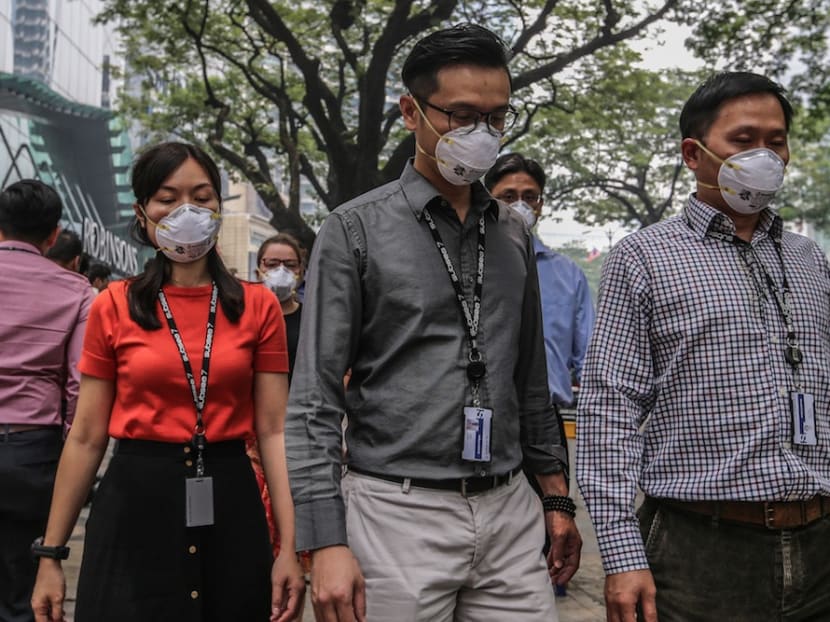 Pedestrians wear masks in Kuala Lumpur, Sept 19, 2019.