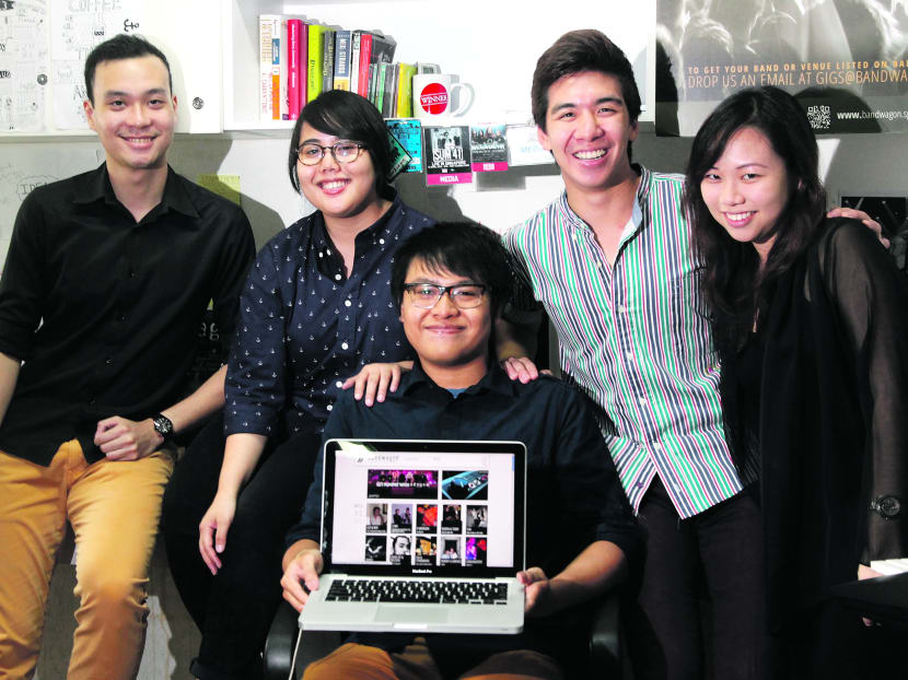 Ms Delfina Utomo (second from left), Mr Ilyas Sholihyn (centre) and Mr Clarence Chan (third from left) with two other members of the Bandwagon.sg team. The website also aims to deliver in-depth editorials on the music scene in Singapore. Photo: Ooi Boon Keong