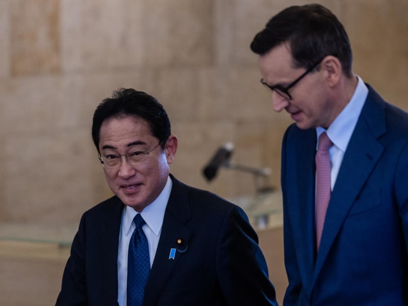 Polish Prime Minister Mateusz Morawiecki (right) and his Japanese counterpart Fumio Kishida arrive for a meeting in Warsaw on March 22.