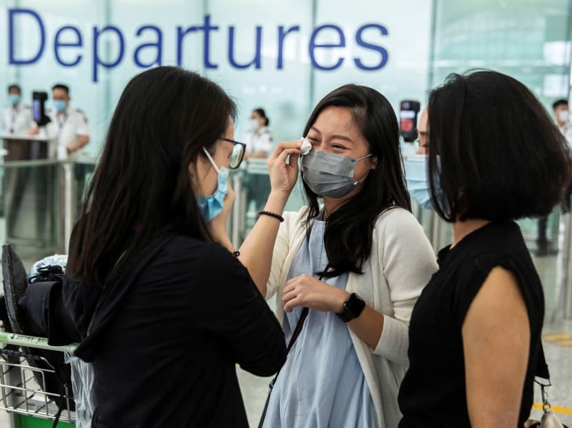 Friends cry at the departure gates of Hong Kong's International Airport before one of them emigrates to Britain on July 19, 2021.