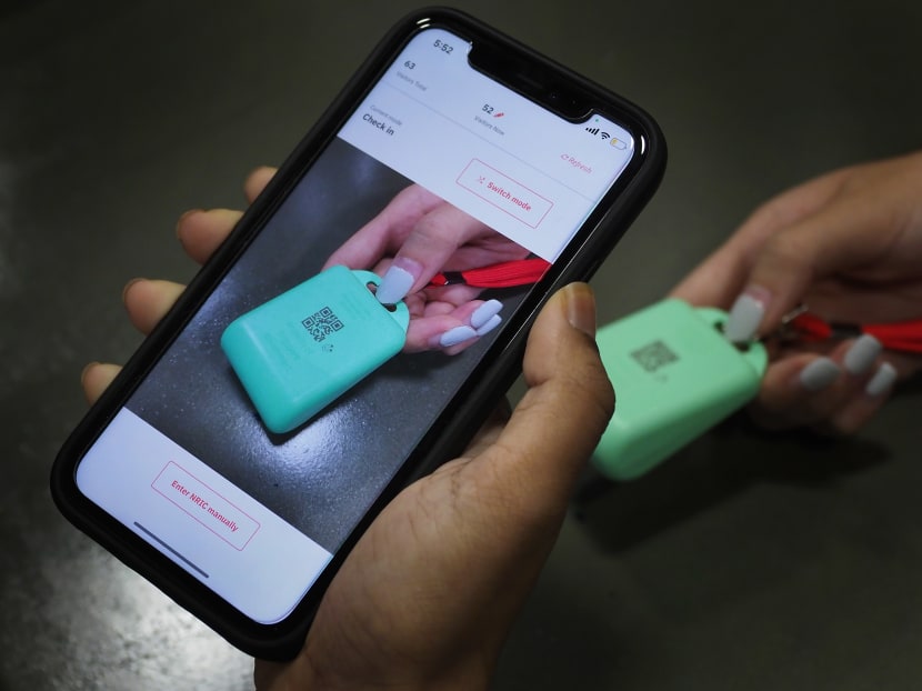 A TraceTogether token being scanned. A TraceTogether token being scanned.