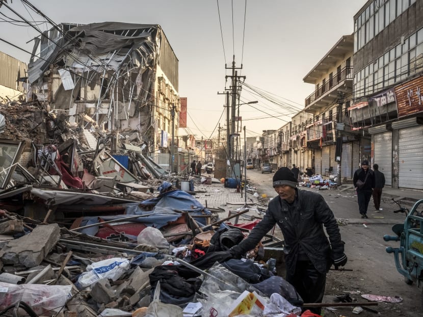 A scavenger looking through debris from demolished buildings in the Xinjiang district of Beijing, on Nov 28, 2017. Tens of thousands of people have already been uprooted in the city’s aggressive drive against migrant neighborhoods, leaving many wondering how much longer they can remain in their homes, or even in Beijing. Photo: The New York Times