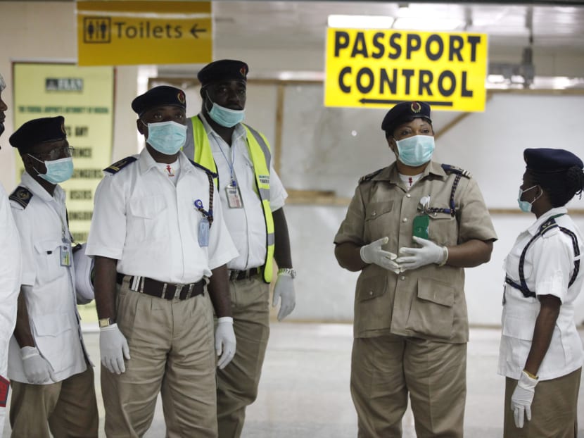 Nigeria health officials wait to screen passengers at the arrival hall of Murtala Muhammed International Airport in Lagos, Nigeria, on Aug 4, 2014. Photo: AP