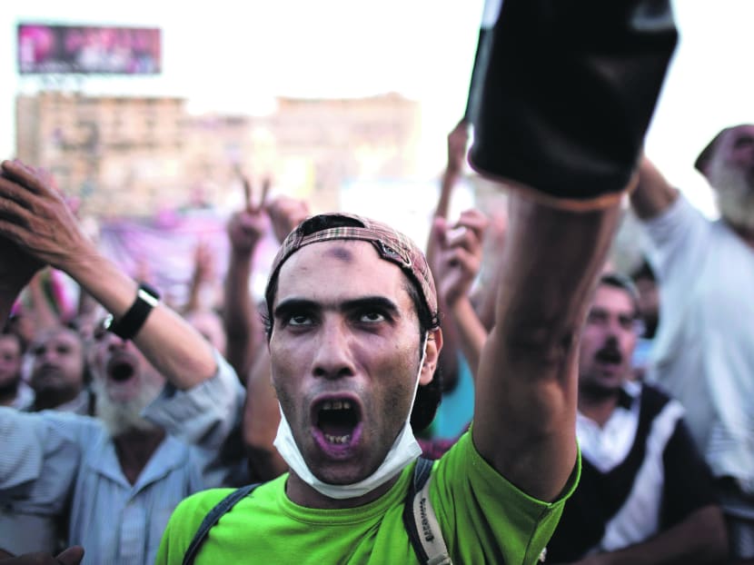 A Morsi supporter chanting slogans against the army during a protest at the Rabaah Al Adawiya mosque. Photo: AP