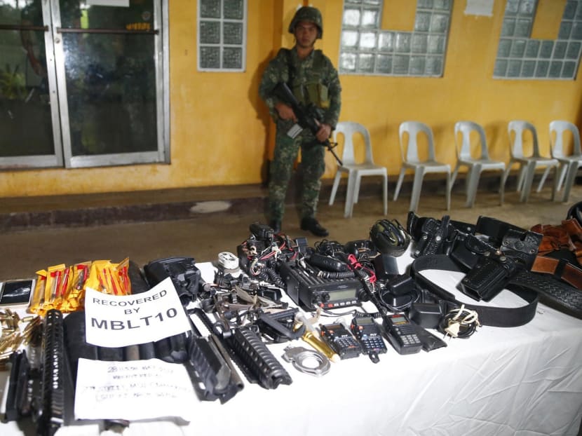 Some of the items recovered by the armed forces in Marawi City include high-powered firearms such as a 50-calibre machine gun, ammunitions, black IS-style flags, and materials that can be used to construct improvised explosive devices. Photo: AP