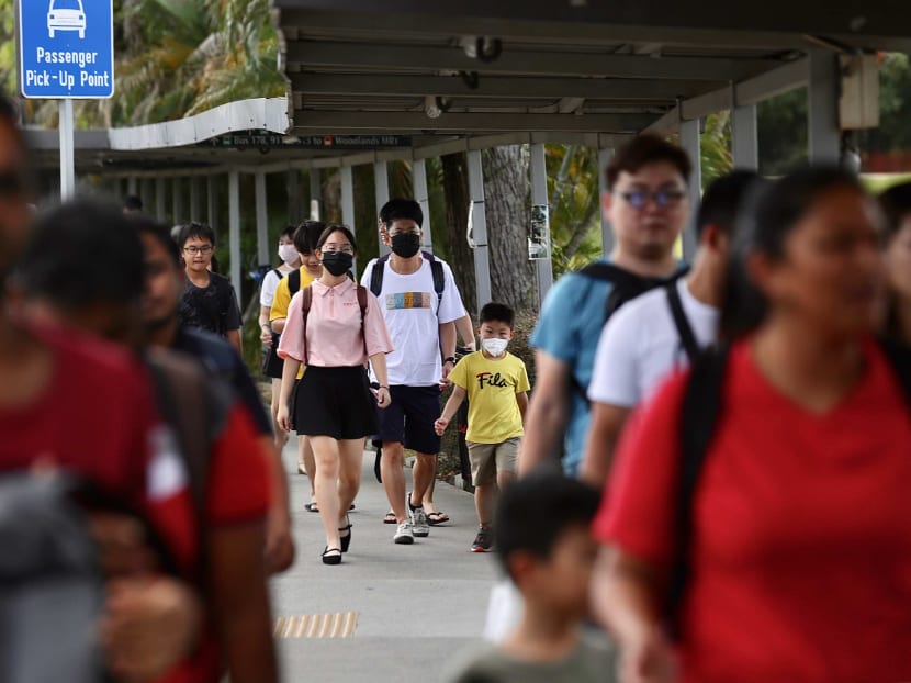 People wearing face masks outside Woodlands checkpoint. People wearing face masks outside Woodlands checkpoint.