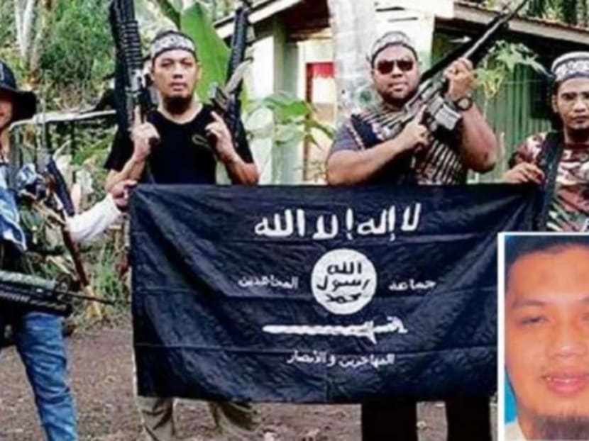 Mahmud Ahmad (second from left and inset) seen here with other militants in southern Philippines. Putrajaya said Mahmud who was tipped to take over as head of the Islamic State (IS) in South-east Asia, is presumed dead. Photo: New Straits Times