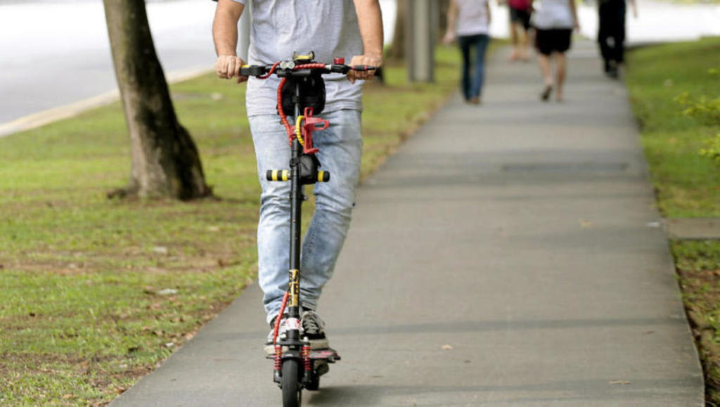 Jail, fine for police NSman who swung e-scooter at LTA officer after riding illegally on footpath