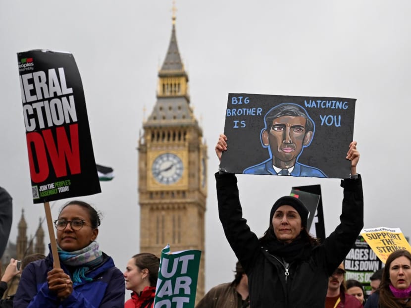 Demonstrators take part in a march past the Houses of parliament during a national demonstration in central London on Nov 5, 2022. 
